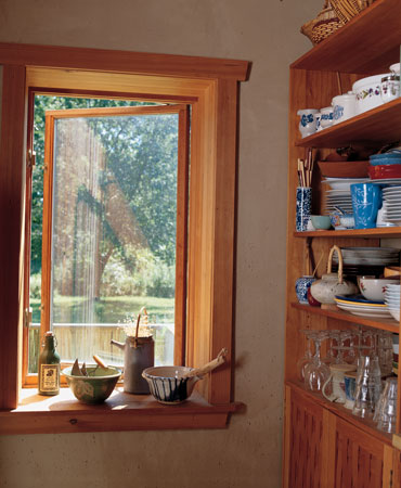 Straw-clay walls twelve inches thick allow for deep window wells. The kitchen cabinets were handcrafted using woven Douglas fir and hand-planed cedar frames and finished with Japanese hand-forged hardware.